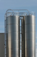 View of an industrial plant with large aluminum tanks
