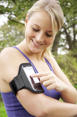 Junge Frau beim Joggen mit Smartphone