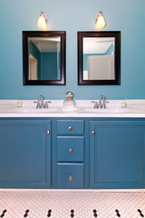 Blue and white classic modern new bathroom with double sinks.
