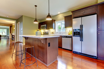 Modern new brown kitchen with cherry floor.