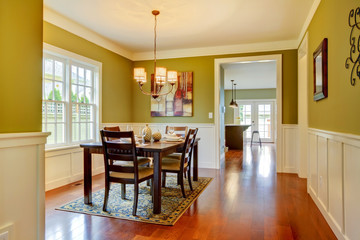 Green craftsman large dining room with cherry floor.