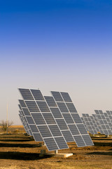Modern solar power plant in the sunny plain.