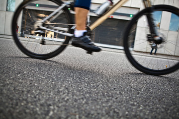 Fototapeta na wymiar Man cycling on city street
