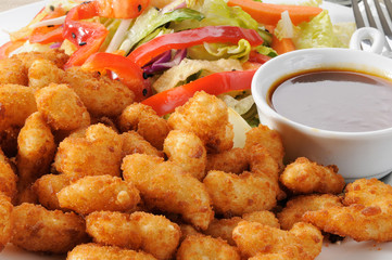 Breaded shrimp and salad close up