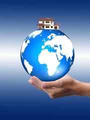 hand holding globe to protect the fragile environment