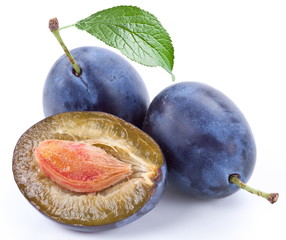 Group of plums with leaf.
