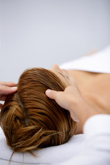 Fototapeta premium Woman being treated to soothing head massage