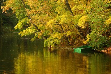 Small green boat on the Beautiful lake