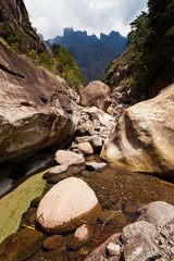 Dry riverbed with mountains in the background