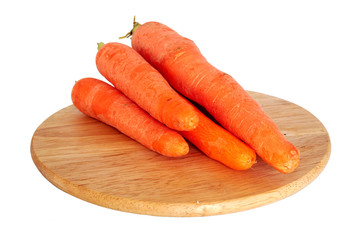 Fresh carrots on wooden board