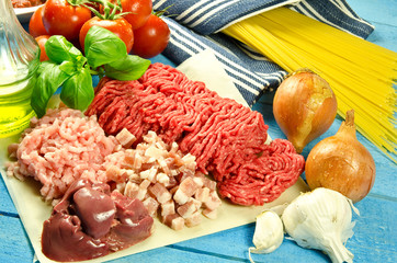 ingredients to make spaghetti bolognese blue background