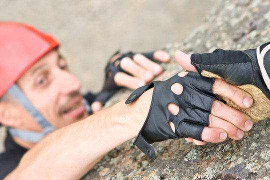 The help two rock-climbers each other in outdoor