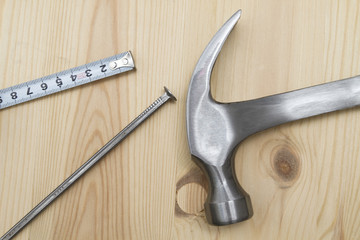 Old hammer , tape measure and nail