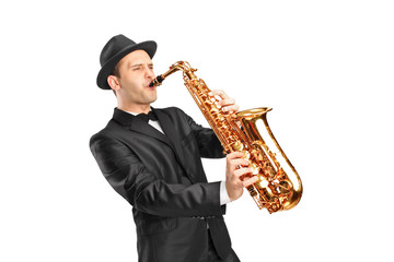 Young man wearing hat and playing on saxophone