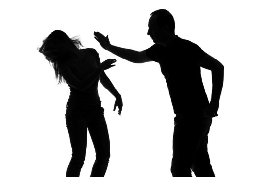 Silhouette of a man slapping a woman