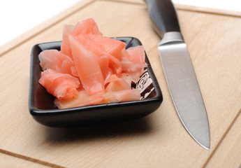 pink ginger ingredient for sushi on wooden board. isolated