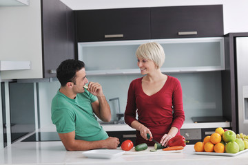 young couple have fun in modern kitchen