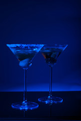 Two martini glasses with blue light