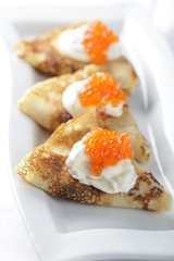 Blinis with red caviar