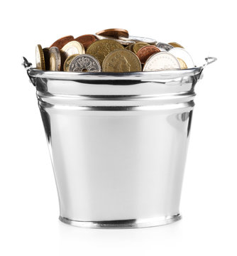 bucket full of coins over white