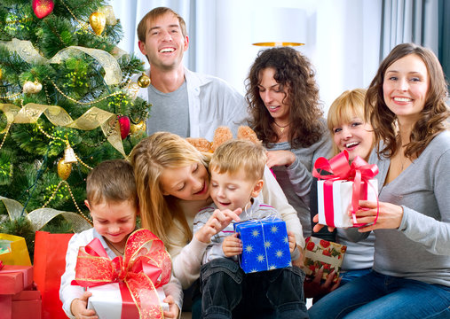 Happy Big Family Holding Christmas Presents At Home