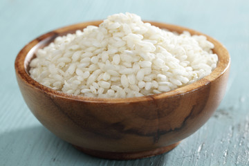 Raw arborio rice in bamboo bowl