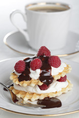 Breakfast with waffles, yogurt, raspberry, and chocolate