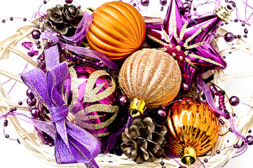Lilac and gold Christmas baubles on white background