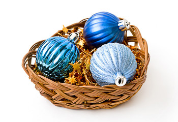 Blue Christmas balls in wicker vase isolated on white backgroun