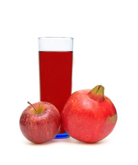 red apple, pomegranate, and a glass of juice on a white backgrou