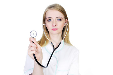 Smiling doctor in white coat using stethoscope isolated