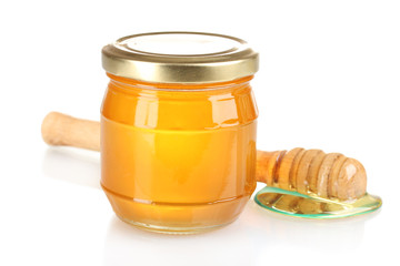 Jar of honey and wooden drizzler isolated on white