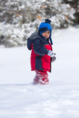 Fototapeta na wymiar Child walking on snow almost knee deep