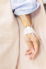 Patient's hand with an intravenous drip before surgery
