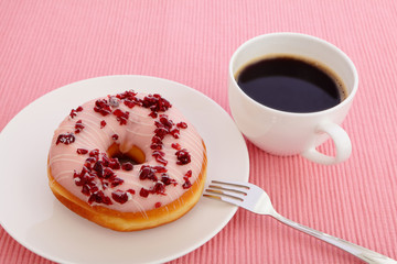 sweet cranberry donut with a cup of coffee
