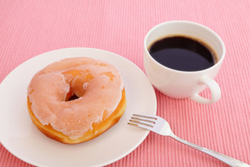 sweet sugar donut with a cup of coffee