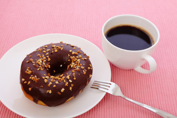 sweet chocolate donut with a cup of coffee