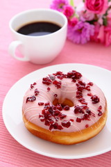 sweet cranberry donut with a cup of coffee and flower