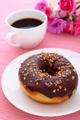 sweet chocolate donut with a cup of coffee