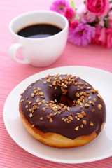 sweet chocolate donut with a cup of coffee
