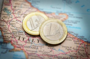 Closeup of Italy on a map and Euro coins