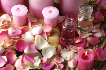 Petals of colorful roses and burning pink candles