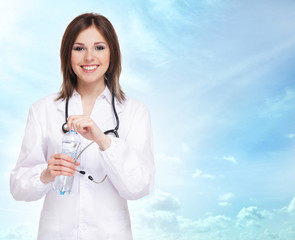 Young and attractive female doctor over abstract background