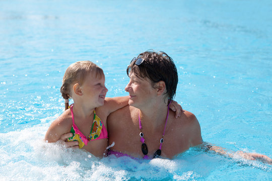 girl with grandmother in the swimming pool