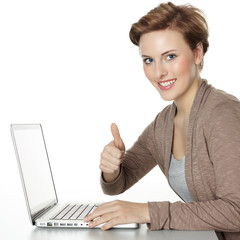 Young pretty girl surfing on the internet and shows thumb up
