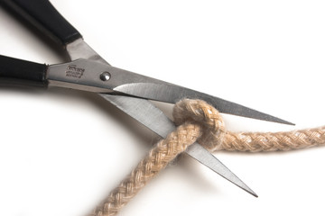 Scissors cutting a rope