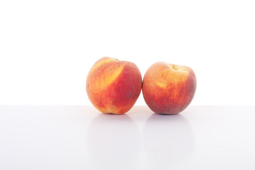 Two Peaches on White Table