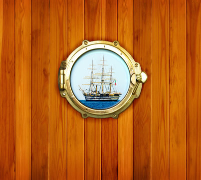 Brass portholes with view to the old sailing vessel