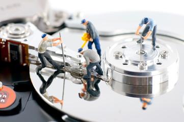 Group of workers repair hard drive