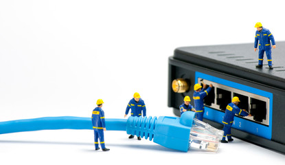 Technicians connecting network cable - obrazy, fototapety, plakaty